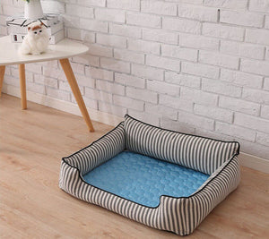 Blue cooling mat fitted inside dog basket for extra relief.