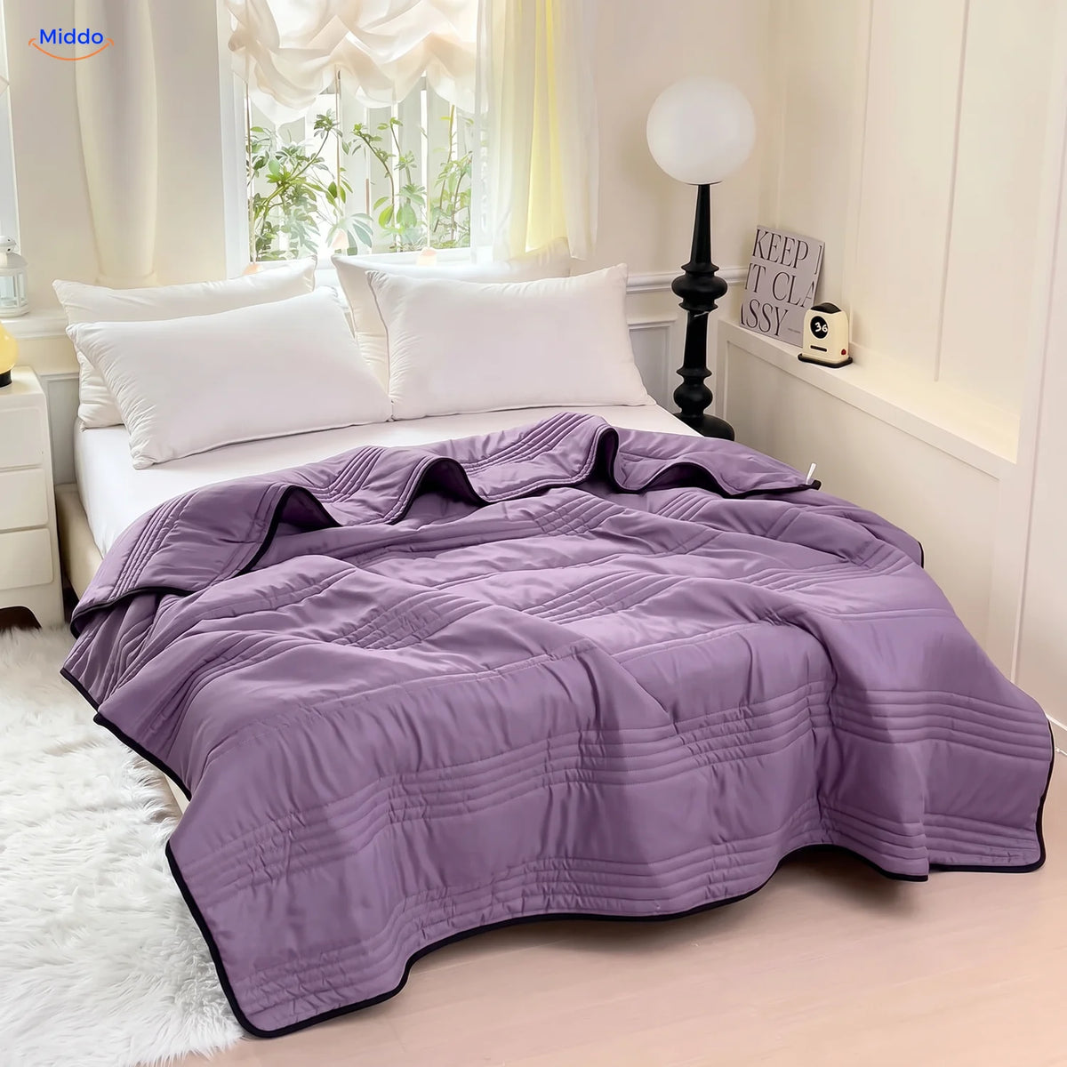 Coolwave cooling blanket in purple on a made bed