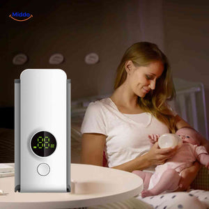 Cordless bottle warmer used by a mother feeding her baby during a nighttime session