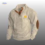 Light gray corduroy sweater featuring warm brown accent details.