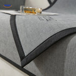 Gray sofa cover styled on corner seating with matching pillows, demonstrating fit and cushion compatibility.