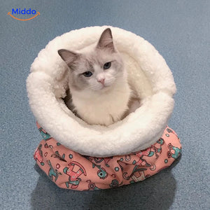 Cozy cat bed in pink rocking horse pattern with cat inside.