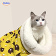 Cozy cat bed in yellow bear pattern with cat resting inside.