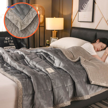 Neutral grey wool blanket showing soft plush texture and bedding styling.