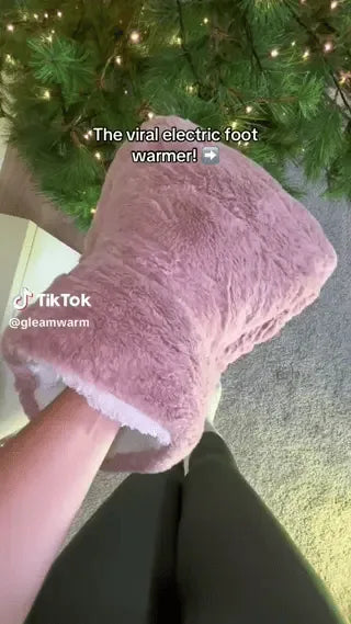 Person enjoying CozyPaws heated foot warmer during relaxation time.