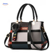 Cute pom-pom tassel accent on handbag with varied color shading.