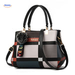 Cute pom-pom tassel accent on handbag with varied color shading.