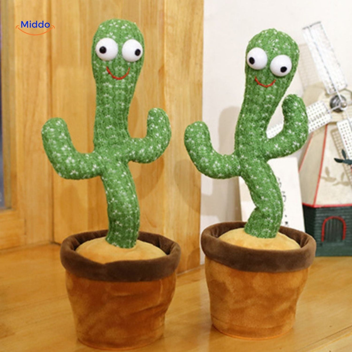 Two dancing cactus toys with LED lights displayed on table.