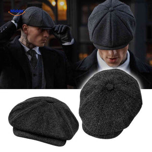 Dark gray wool peaky cap with heritage newsboy style and all-season warmth.