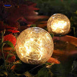 Decorative LED solar lamp nestled in flower pot planter lighting.