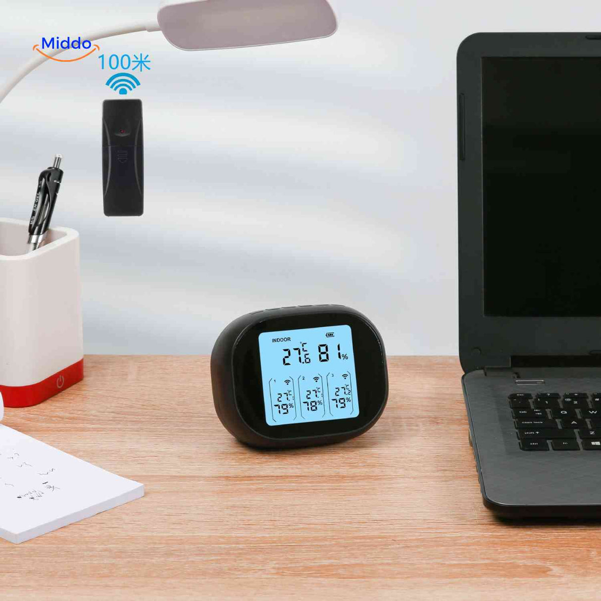 Desktop thermometer-hygrometer with wireless sensor displaying temperature and humidity.