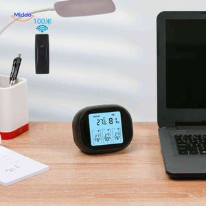 Desktop thermometer-hygrometer with wireless sensor displaying temperature and humidity.