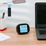 Desktop thermometer-hygrometer with wireless sensor displaying temperature and humidity.