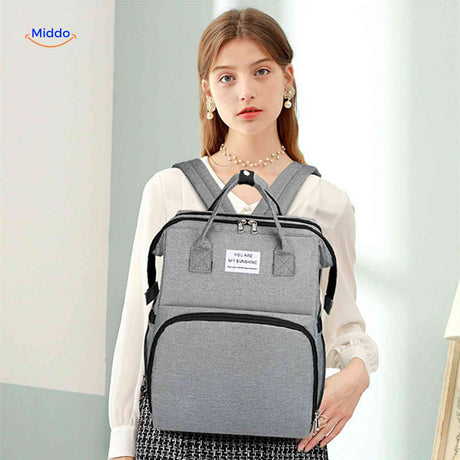 Gray BabyLuxe diaper backpack with stylish design and foldable bassinet feature.