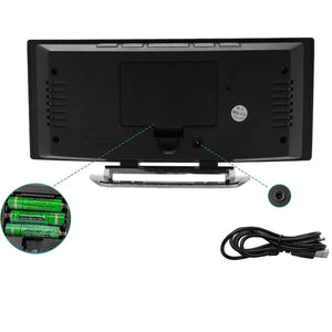 Back view of alarm clock showing battery compartment and USB power charging port.