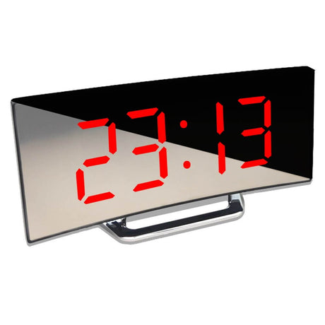 Close-up of red LED display showing time 23:13 on curved digital alarm clock.