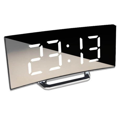 Close-up of white LED display showing time 23:13 on curved digital alarm clock.