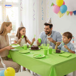 Green disposable party tableware set with plates, cups, cutlery, and coordinating colors.