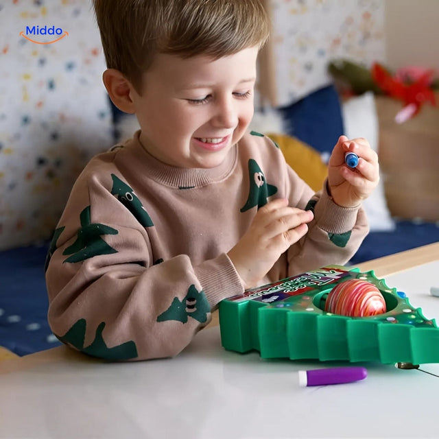 Young child smiling while painting wooden ornaments with electric pen from TreeMendous DIY kit.