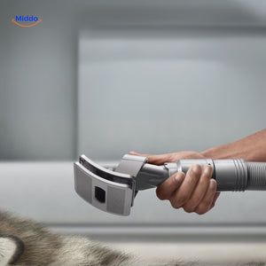 Dog grooming brush with compatible vacuum nozzle attachment.