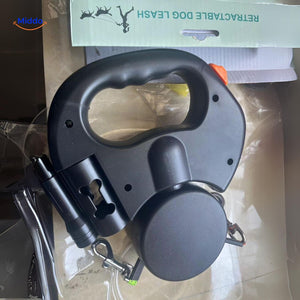 Retractable dog leash in product packaging showing ergonomic handle.