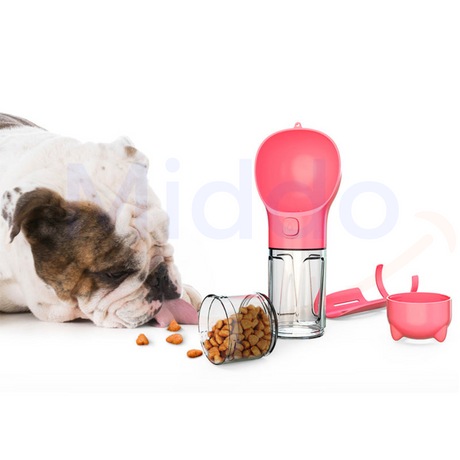 Pink dog water bottle being used by bulldog outdoors.