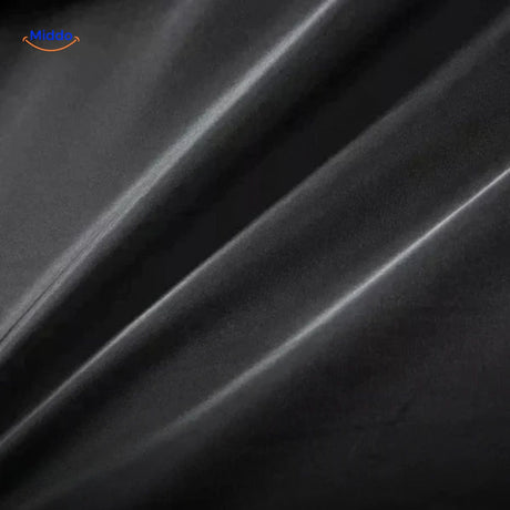 Close-up of the black wool coat fabric showing the dense, premium wool texture and weave.