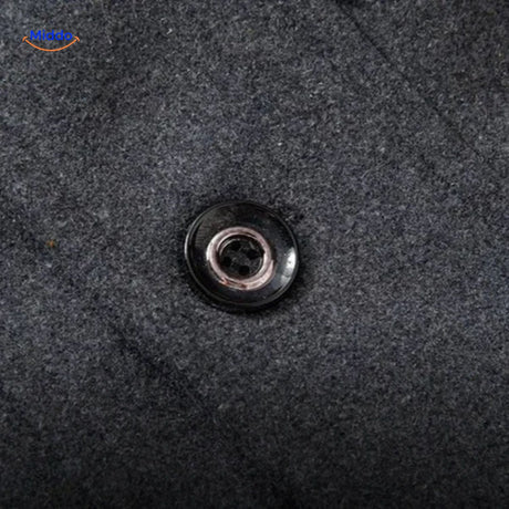 Close-up of the buttons on the grey wool coat showing quality button finish and stitching.