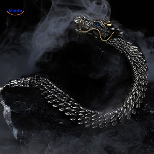 Dragon bone bracelet emerging from shadows in a dramatic styling shot.