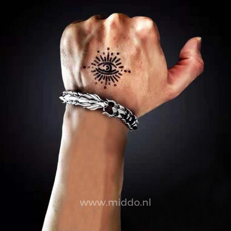 Viking dragon bracelet worn on a tattooed wrist, showcasing its bold Norse styling.