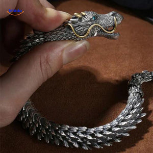 Dragon head detail with striking blue eyes showing intricate carving and design.