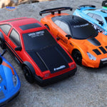 Red and orange 4WD drift RC cars racing together demonstrating multi-car play