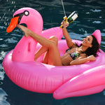Woman using beergun on inflatable float at pool party