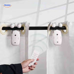 Dual smart curtain motors with remote control on curtain rod.