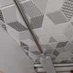 Duster reaching along wall baseboards and trim edges.
