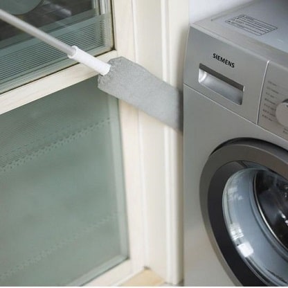 Extended duster cleaning dust from the side of washing machine.