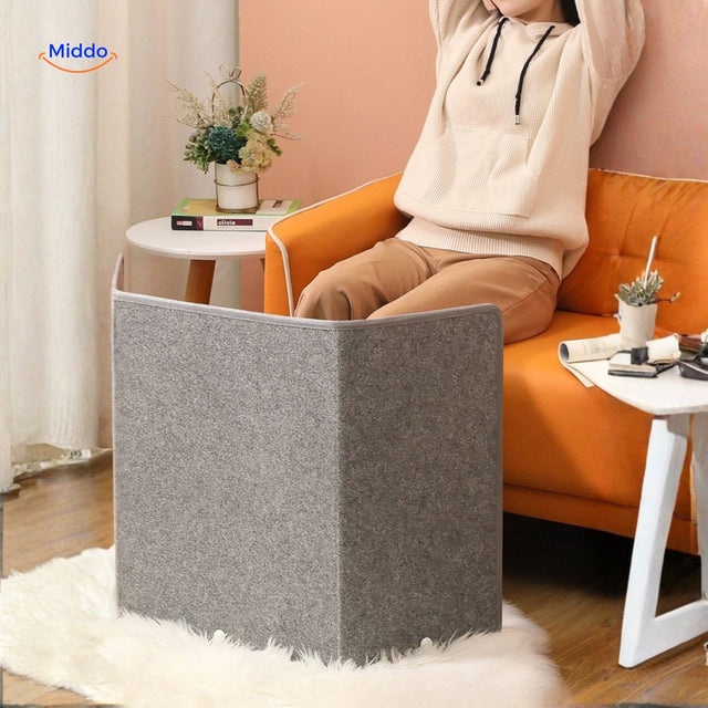 Electric leg warmer with infrared heating keeping feet warm on couch.