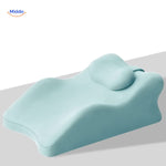 Blue leg elevation pillow with combined support for legs, head and neck comfort.