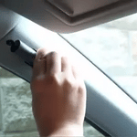 SafeKey Pro escape tool being used to break car window in emergency situation.