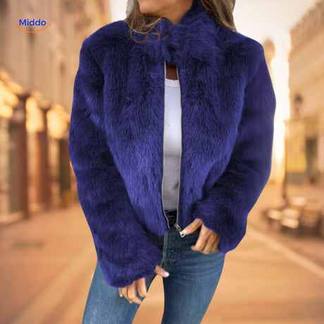 Women's blue faux fur coat with high collar in elegant lifestyle setting.