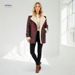 Bordeaux red long faux fur coat with faux leather panel details and warm lining, side view.