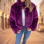 Faux fur coat features and design details including high collar styling.