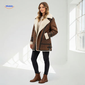 Long faux fur lined winter coat in a complete outfit with ankle boots, editorial lifestyle shot.