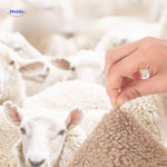 Close-up detail of luxe faux lambswool texture showing soft wool sensation and hand feel.