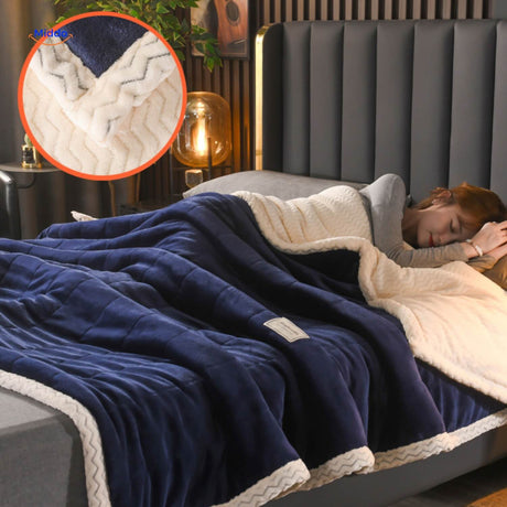 Dark blue and white colorblock plush fleece blanket on bedding.