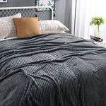 Sleek dark gray velvet fleece blanket matches modern interiors.