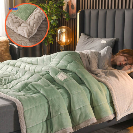 Green and grey two-tone wool blanket on bedding arrangement.