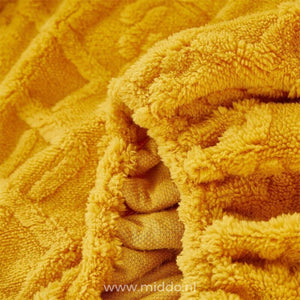Comfortable fleece fitted sheet creating cozy bedding setup.