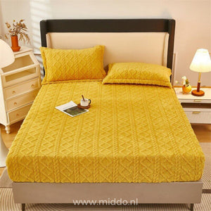 Fleece fitted sheet styled on bed showing softness and warmth.