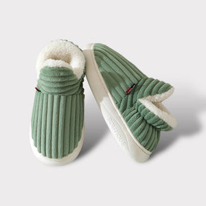 Close-up lifestyle view of green therapeutic slippers showing comfort and quality construction.